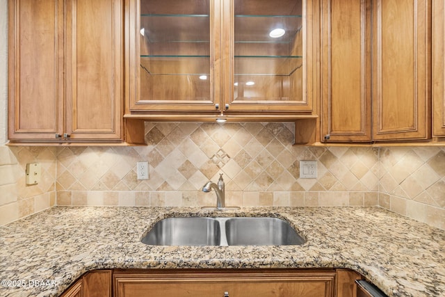 2987 S Atlantic Ave Unit 903, Daytona Beach Shores, FL 32118 - kitchen featuring a sink, brown cabinets, and light stone counters