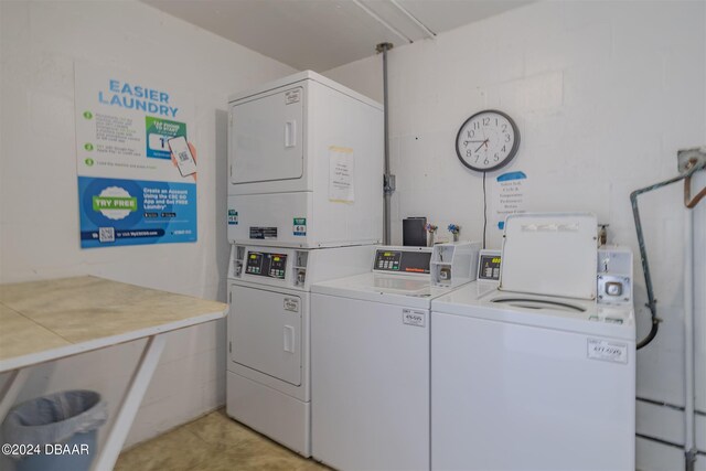 clothes washing area with stacked washer and dryer and washing machine and dryer