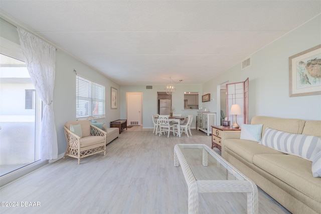 living room featuring an inviting chandelier and wood-type flooring