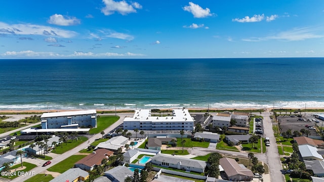 birds eye view of property with a beach view and a water view