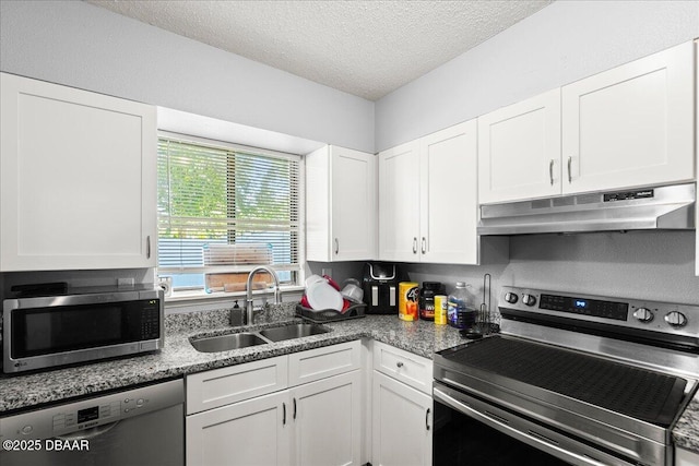 kitchen featuring appliances with stainless steel finishes, white cabinets, a sink, a textured ceiling, and under cabinet range hood