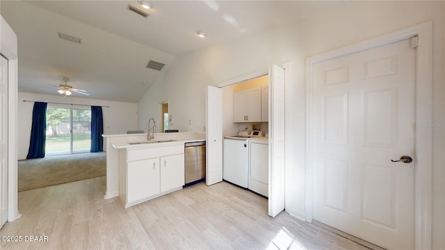 49 Felshire Ln, Palm Coast, FL 32137 - kitchen with dishwasher, a peninsula, washer and clothes dryer, lofted ceiling, and a sink