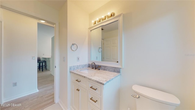49 Felshire Ln, Palm Coast, FL 32137 - half bathroom with toilet, vanity, wood finished floors, and baseboards
