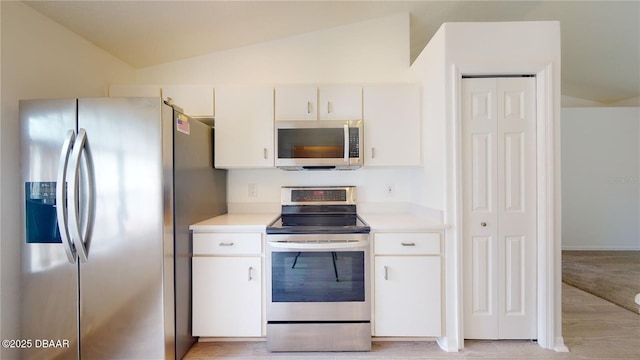 49 Felshire Ln, Palm Coast, FL 32137 - kitchen featuring appliances with stainless steel finishes, vaulted ceiling, light countertops, and white cabinets