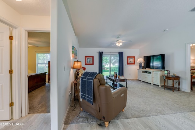 49 Felshire Ln, Palm Coast, FL 32137 - living room featuring ceiling fan, light wood-style floors, and light colored carpet