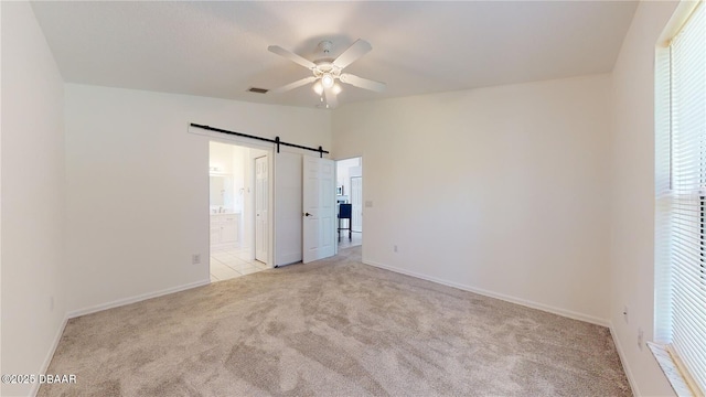 49 Felshire Ln, Palm Coast, FL 32137 - unfurnished bedroom with carpet, baseboards, multiple windows, and a barn door