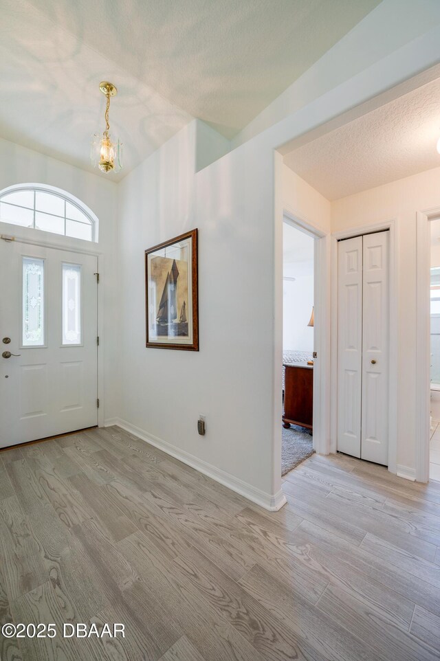 49 Felshire Ln, Palm Coast, FL 32137 - entrance foyer featuring wood finished floors and a chandelier