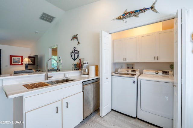 49 Felshire Ln, Palm Coast, FL 32137 - washroom with cabinet space, independent washer and dryer, and light wood-style flooring