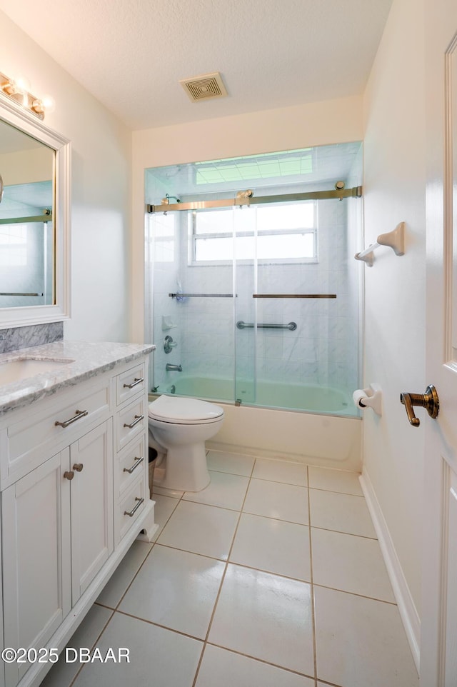 49 Felshire Ln, Palm Coast, FL 32137 - bathroom with vanity, enclosed tub / shower combo, and tile patterned flooring