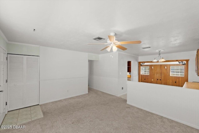 interior space featuring light colored carpet and ceiling fan