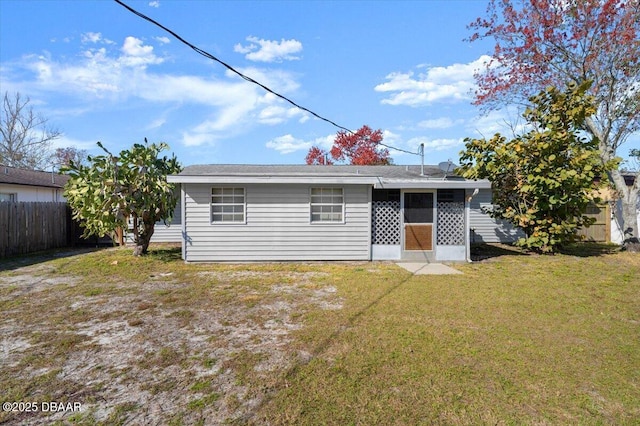 rear view of property with a yard