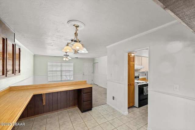 kitchen with light tile patterned flooring, ornamental molding, a textured ceiling, and range with electric stovetop