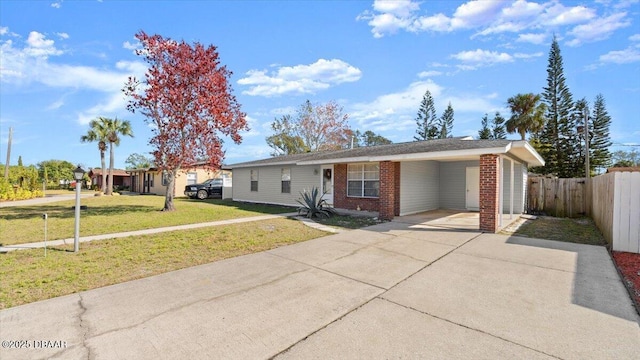 ranch-style house featuring a front lawn and a carport