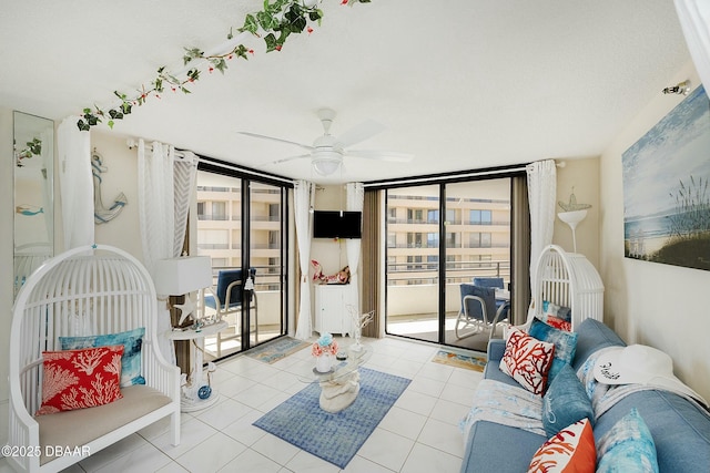 living area with tile patterned flooring, floor to ceiling windows, and a ceiling fan