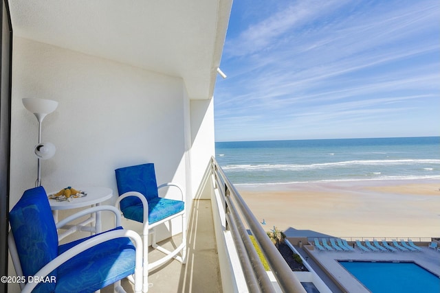 balcony with a view of the beach and a water view