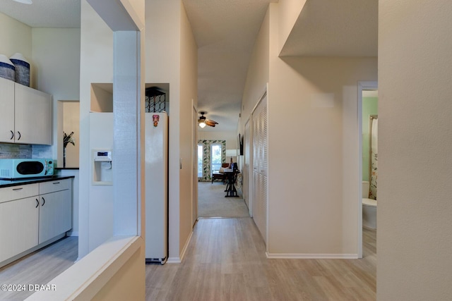 118 Lagoon Ct, New Smyrna Beach, FL 32169 - hallway with baseboards and light wood-style flooring
