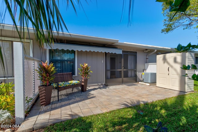 118 Lagoon Ct, New Smyrna Beach, FL 32169 - back of house with board and batten siding, a patio, and central AC