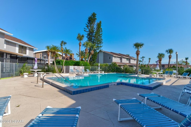 118 Lagoon Ct, New Smyrna Beach, FL 32169 - community pool with a patio area, fence, and a residential view