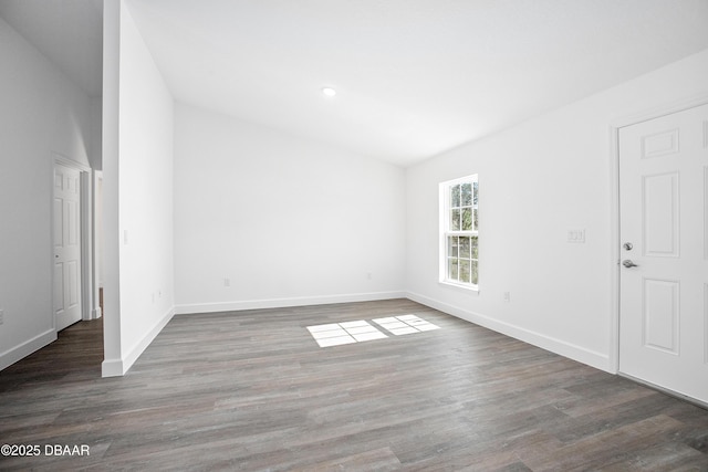 empty room with dark hardwood / wood-style flooring