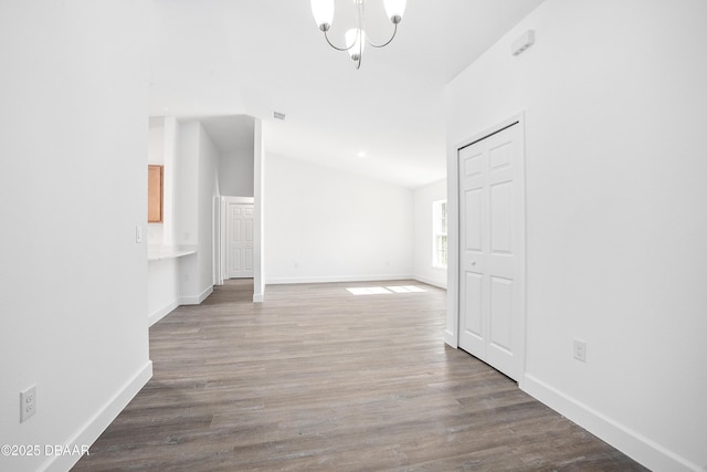 hallway featuring hardwood / wood-style floors and a chandelier