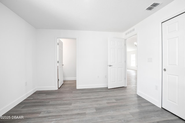 interior space with ensuite bathroom and light hardwood / wood-style flooring