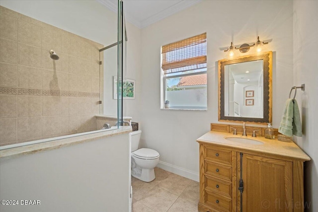 bathroom featuring tile patterned flooring, a tile shower, vanity, ornamental molding, and toilet