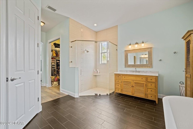 bathroom featuring independent shower and bath and vanity