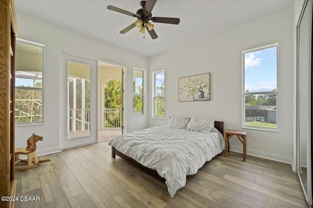 bedroom with ceiling fan, access to outside, and light hardwood / wood-style floors