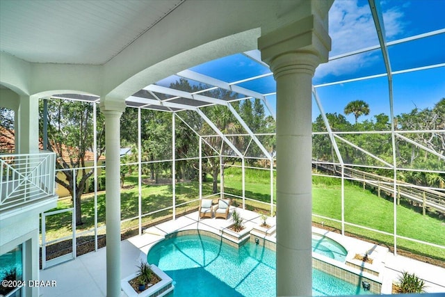 view of pool with a lanai, a patio area, and a lawn