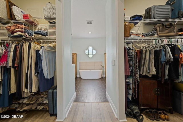 spacious closet featuring hardwood / wood-style flooring