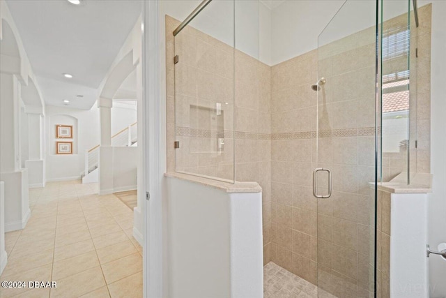 bathroom with tile patterned floors and an enclosed shower