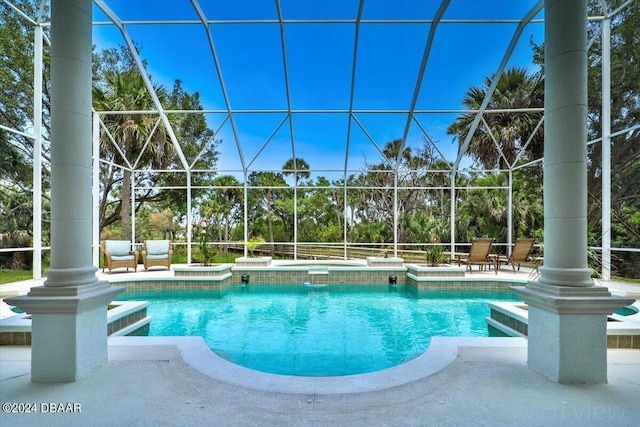 view of swimming pool featuring a patio and glass enclosure