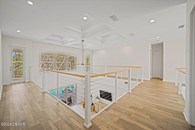 corridor with coffered ceiling, hardwood / wood-style flooring, and beam ceiling