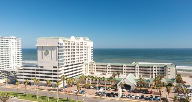 view of building exterior with a view of the beach and a water view