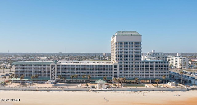 view of city featuring a beach view and a water view