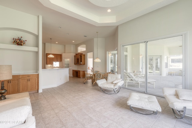 living room featuring light tile patterned floors and a high ceiling