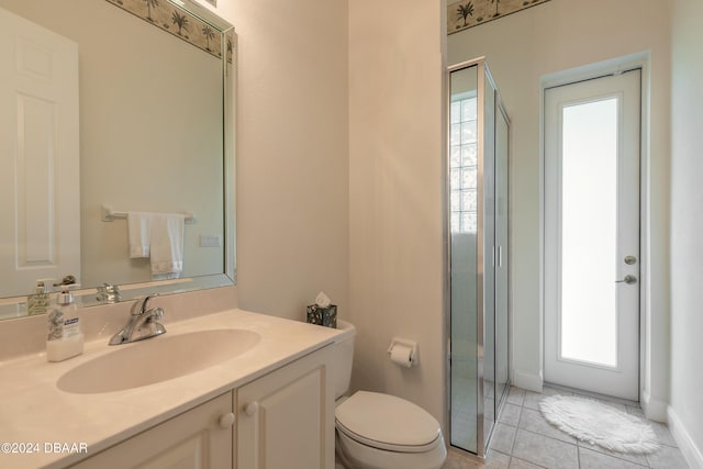 bathroom featuring a wealth of natural light, tile patterned floors, vanity, and toilet