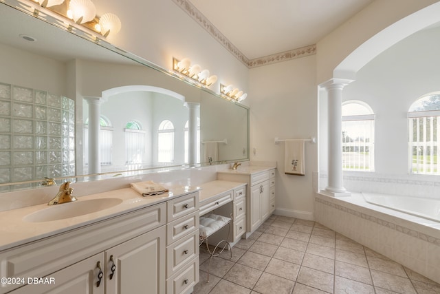 bathroom featuring vanity, tiled bath, and tile patterned floors