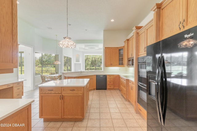 kitchen featuring black appliances, light tile patterned floors, sink, a kitchen island, and decorative light fixtures