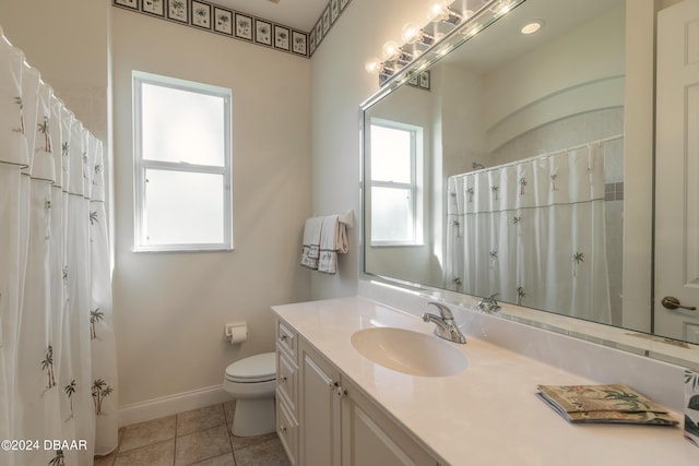 bathroom featuring vanity, tile patterned flooring, and toilet