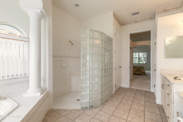 bathroom with decorative columns, vanity, tile patterned flooring, and separate shower and tub