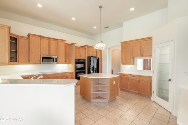 kitchen featuring black appliances, light tile patterned floors, pendant lighting, and a center island