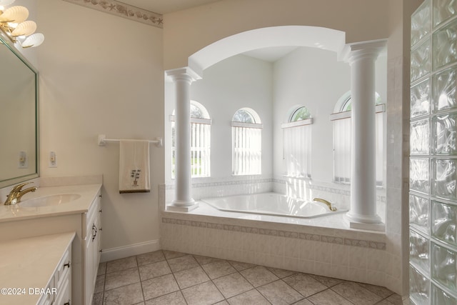 bathroom with tiled bath, tile patterned flooring, and vanity