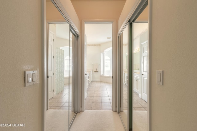 hall featuring light tile patterned floors