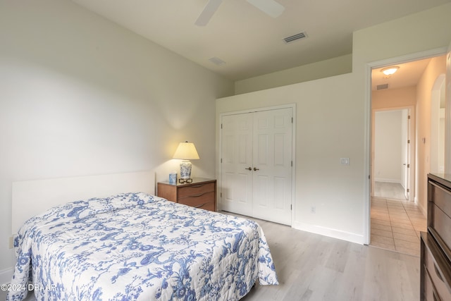 bedroom featuring light wood-type flooring, ceiling fan, and a closet