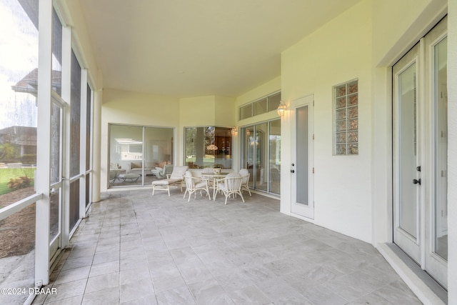 unfurnished sunroom with french doors