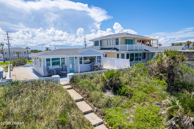 view of front of property with a patio area and a balcony