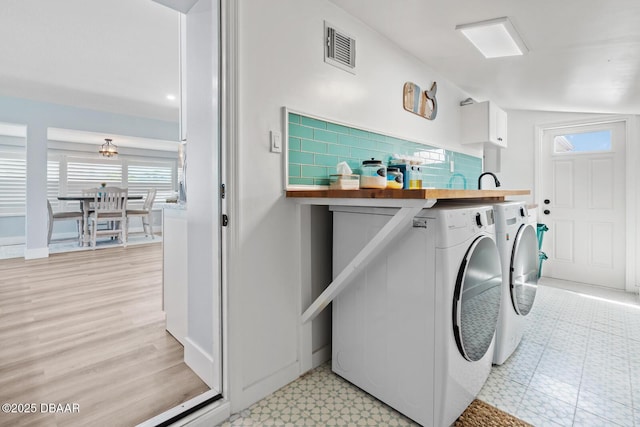 clothes washing area with independent washer and dryer