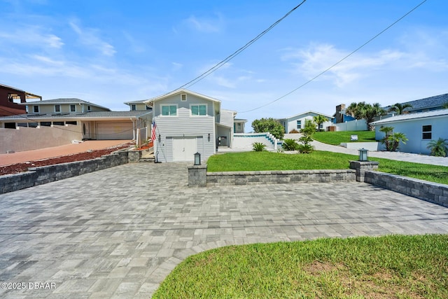 view of front of home featuring a front lawn and a garage