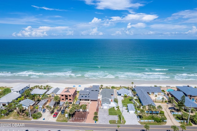 drone / aerial view with a water view and a view of the beach